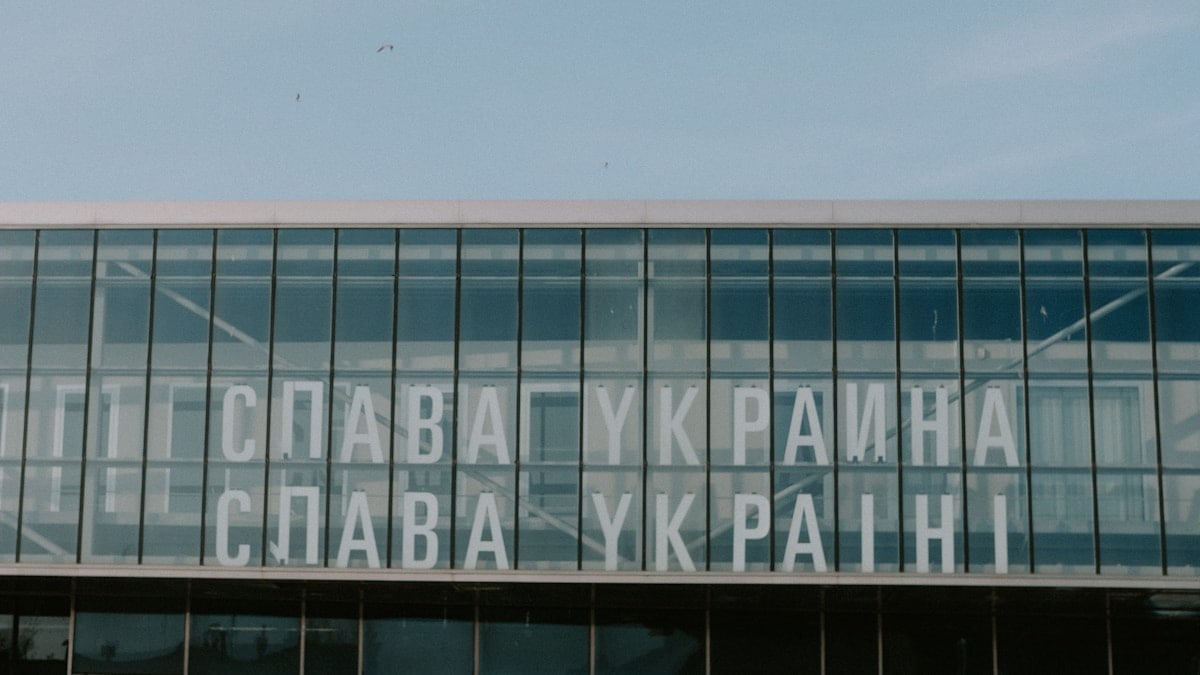 a large glass building with a sky background